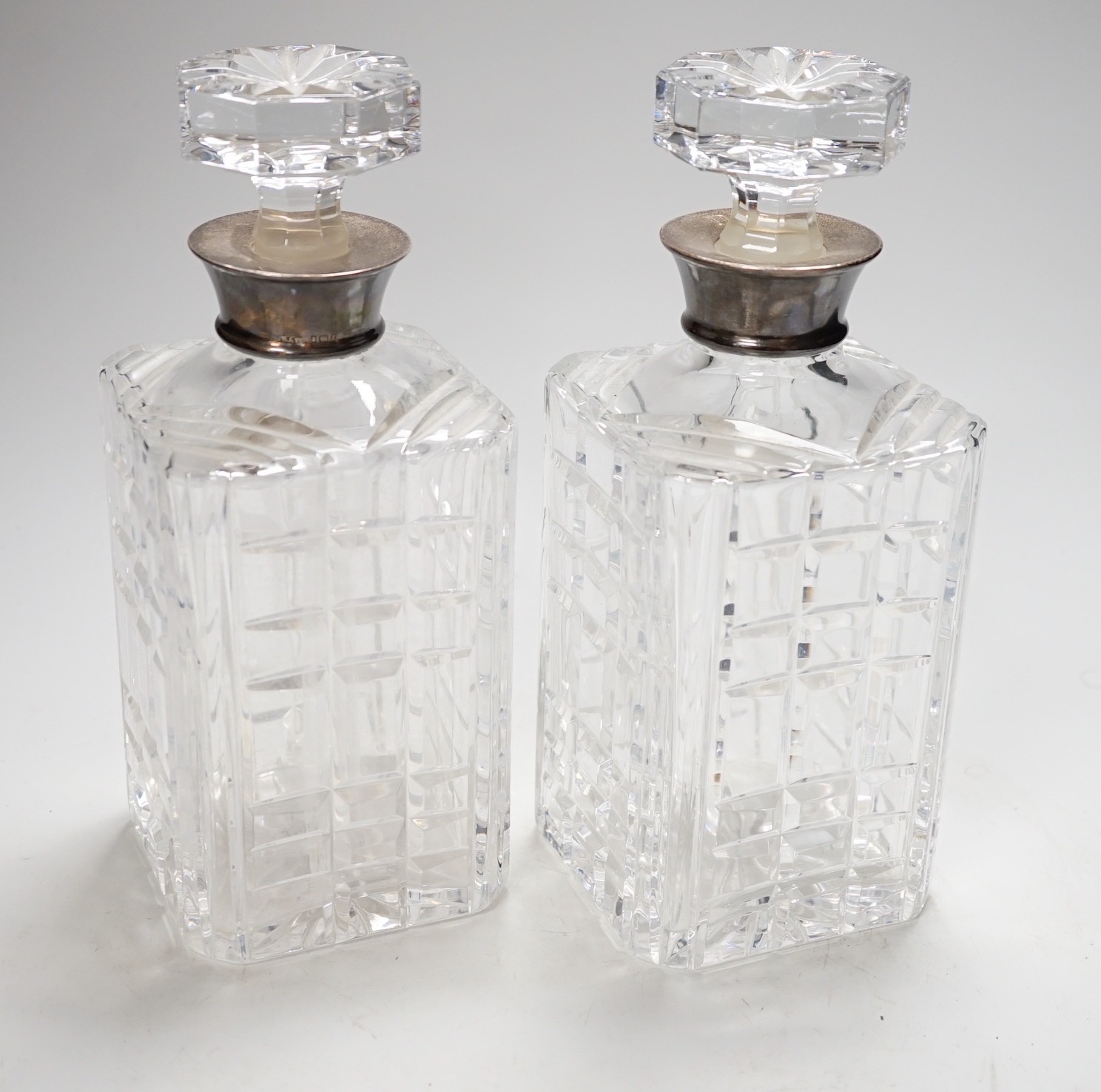 A pair of 20th century silver collared glass decanters and stoppers by Roberts & Dore Ltd, 24cm